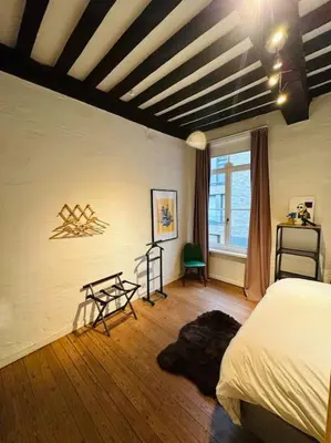 a bedroom with a bed and a wooden floor at Charmante woning in city center in Antwerp