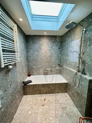 a bathroom with a shower and a bath tub at Sunny apartment @theater area in Antwerp
