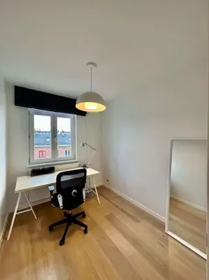an office with a desk and a chair in a room at Sunny apartment @theater area in Antwerp