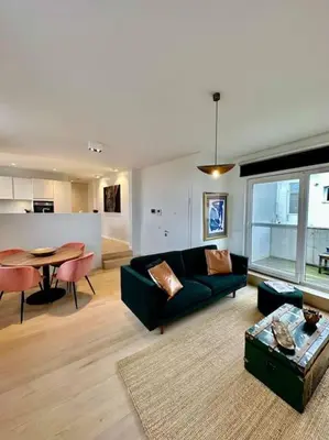 a living room with a couch and a table at Sunny apartment @theater area in Antwerp