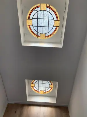 a room with two stained glass windows on the ceiling at #2800ourhome 301 in Mechelen