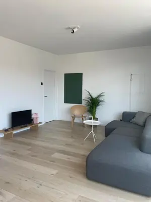 a living room with a couch and a tv at #2800ourhome 301 in Mechelen