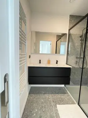 a bathroom with a tub and a sink and a mirror at #2800ourhome 301 in Mechelen
