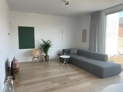 a living room with a couch and a table at #2800ourhome 301 in Mechelen