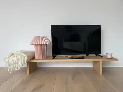 a flat screen tv sitting on a wooden table at #2800ourhome 201 in Mechelen