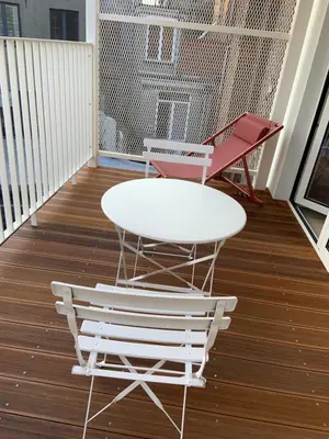 a white table and two chairs on a balcony at #2800ourhome 202 in Mechelen