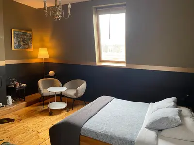 a bedroom with a bed and a table and chairs at Vakantielogies Faja lobi in Ghent