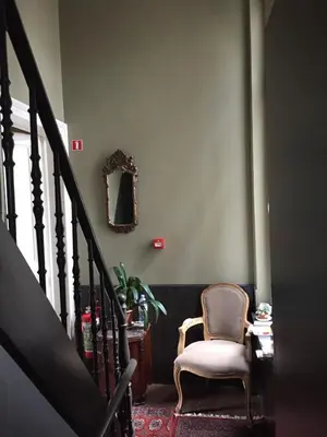 a stairway with a chair and a mirror at Vakantielogies Faja lobi in Ghent
