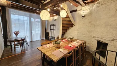 a dining room with a table and a fireplace at CEP ECUYER in Brussels