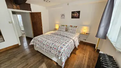 a bedroom with a bed and two lamps in it at CEP ECUYER in Brussels