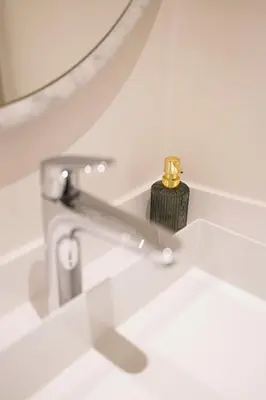 a bathroom sink with a faucet and a mirror at Appartement dans l'hypercentre in Brussels