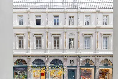 a large white building with statues in front of it at Appartement dans l'hypercentre in Brussels