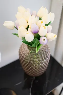 a vase filled with flowers sitting on a table at Appartement dans l'hypercentre in Brussels