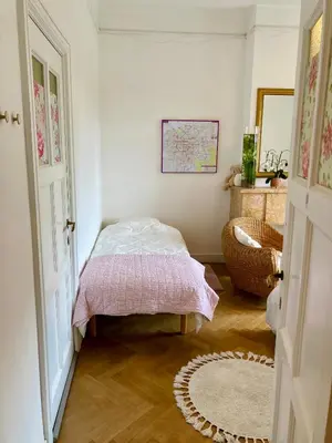 a bedroom with a bed with a pink blanket at Calm, green & birdsong in Brussels