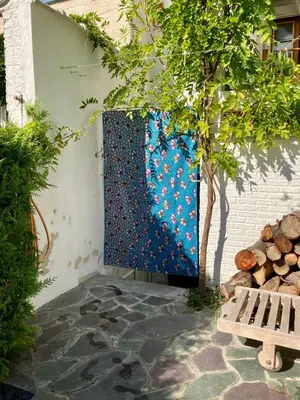 a blue tapestry hanging on the side of a building at Calm, green & birdsong in Brussels
