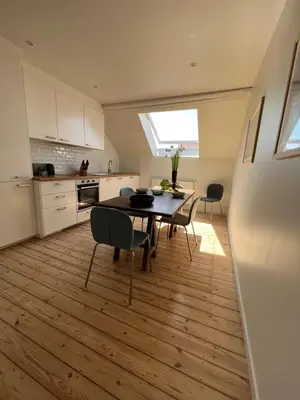a kitchen and dining room with a table and chairs at Cosy Nest in Brussels