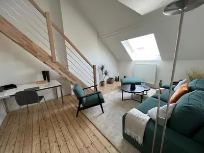 a living room with a green couch and chairs at Cosy Nest in Brussels