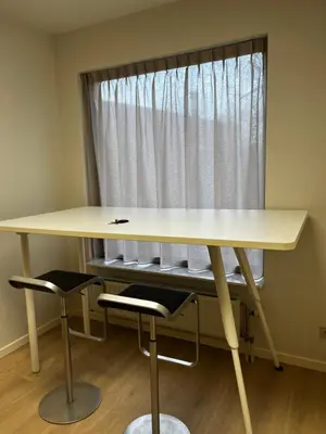 a desk with two chairs in front of a window at Budget Flex in Geel