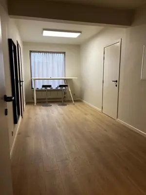 an empty room with a table and a desk at Budget Flex in Geel
