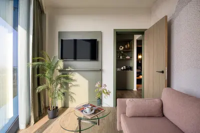 a living room with a couch and a table at voco Brussels City North by IHG in Vilvoorde