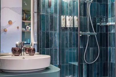 a bathroom with a sink and a shower at voco Brussels City North by IHG in Vilvoorde
