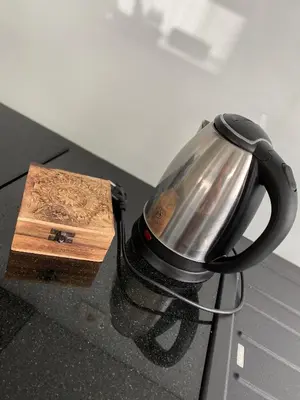 a tea kettle sitting on a counter next to a box at Zwarte Arend AirBnB in Antwerp