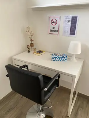 a white desk with a chair and a no smoking sign at Zwarte Arend AirBnB in Antwerp