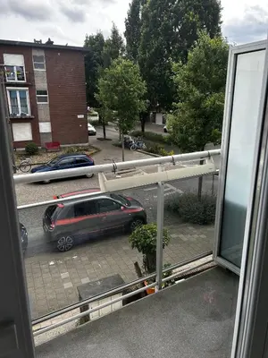 a view of a car parked in a parking lot from a window at Zwarte Arend AirBnB in Antwerp