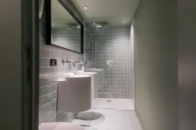 a bathroom with two sinks and a mirror at Maison Arya in Brussels