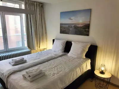 a bedroom with a bed with two towels on it at bel etage woning in Ghent