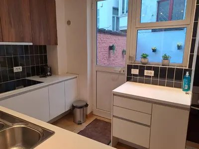 a kitchen with a sink and a window at bel etage woning in Ghent