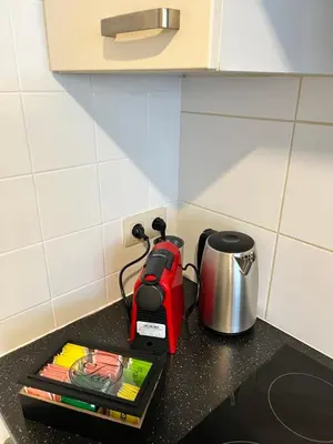 a red toaster sitting on top of a kitchen counter at Vilvoorde city center in Vilvoorde