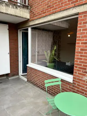 a window with a table and a chair in front of it at Vilvoorde city center in Vilvoorde