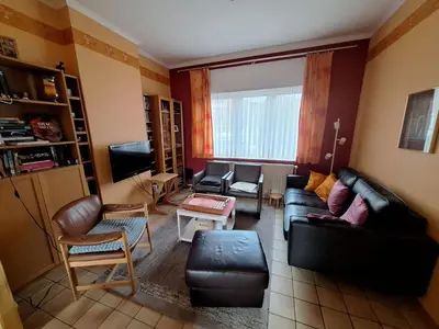 a living room with a couch and chairs and a tv at Feel at home in Leuven in Leuven