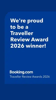a blue sign that says were proud to be a traveller reviewagency winner at Feel at home in Leuven in Leuven