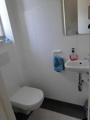 a white bathroom with a toilet and a sink at Feel at home in Leuven in Leuven