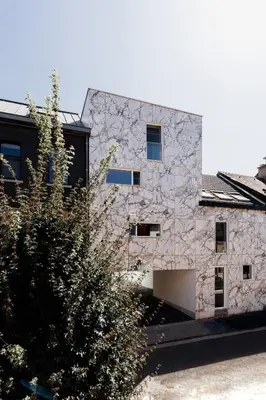 a stone building with a tree in front of it at Befour Vakantiewoning in Aalst