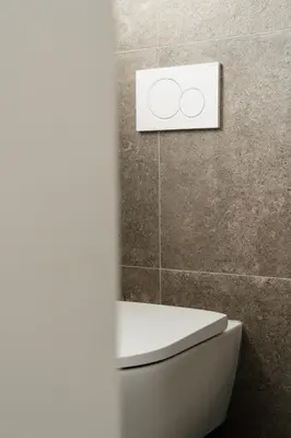 a bathroom with a toilet with a sign on the wall at Befour Vakantiewoning in Aalst