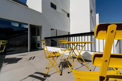 two yellow chairs and a table on a balcony at Befour Vakantiewoning in Aalst
