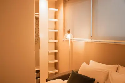a room with a bed and a book shelf at Archimède Suites in Brussels