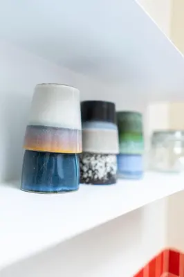 a shelf with three different colored bowls on it at Casa Mina - Dok Noord Ghent in Ghent