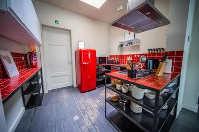 a kitchen with a red refrigerator and red tiles at Casa Mina - Dok Noord Ghent in Ghent