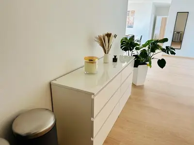 a white dresser with plants in a room at Urbanstay Suites - Grand Place 2 Bd Apartment in Brussels