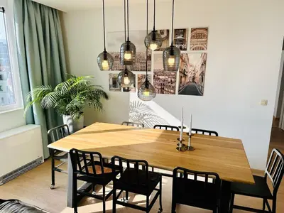 a dining room with a wooden table and chairs at Urbanstay Suites - Grand Place 2 Bd Apartment in Brussels