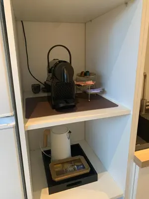 a cupboard with a backpack sitting on a shelf at Q Guesthouse in Herzele