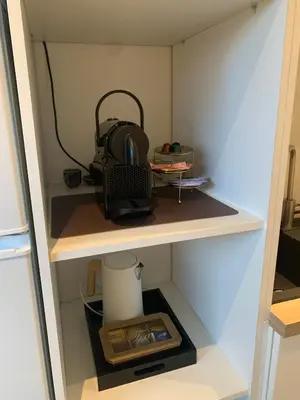 a cupboard with a backpack sitting on a shelf at Q Guesthouse in Herzele
