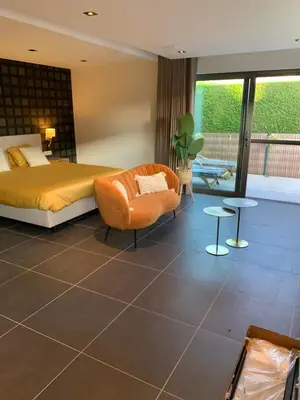 a bedroom with a bed and a chair at Q Guesthouse in Herzele