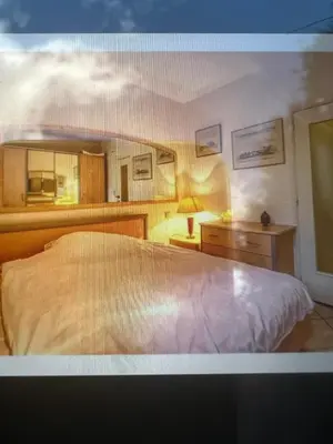 a bedroom with a large white bed and a lamp at Appartements Brussels in Brussels