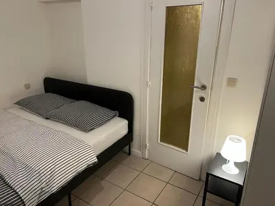 a bedroom with a bed and a lamp on a table at Appartements Brussels in Brussels