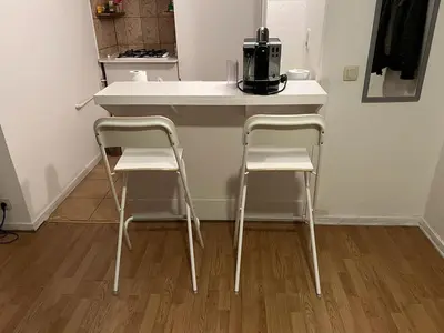 a kitchen with two chairs and a table with a microwave at Appartements Brussels in Brussels